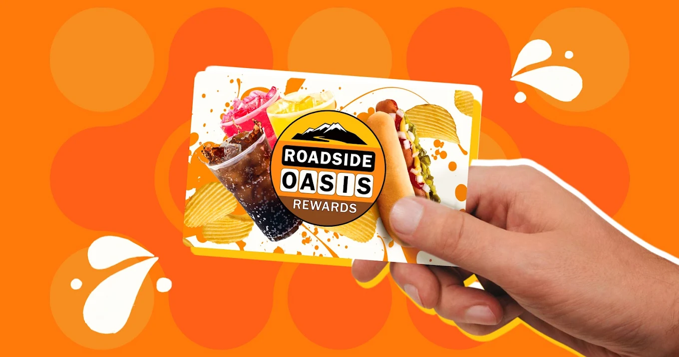 Driver holding a Roadside Oasis Rewards card in Menifee, CA